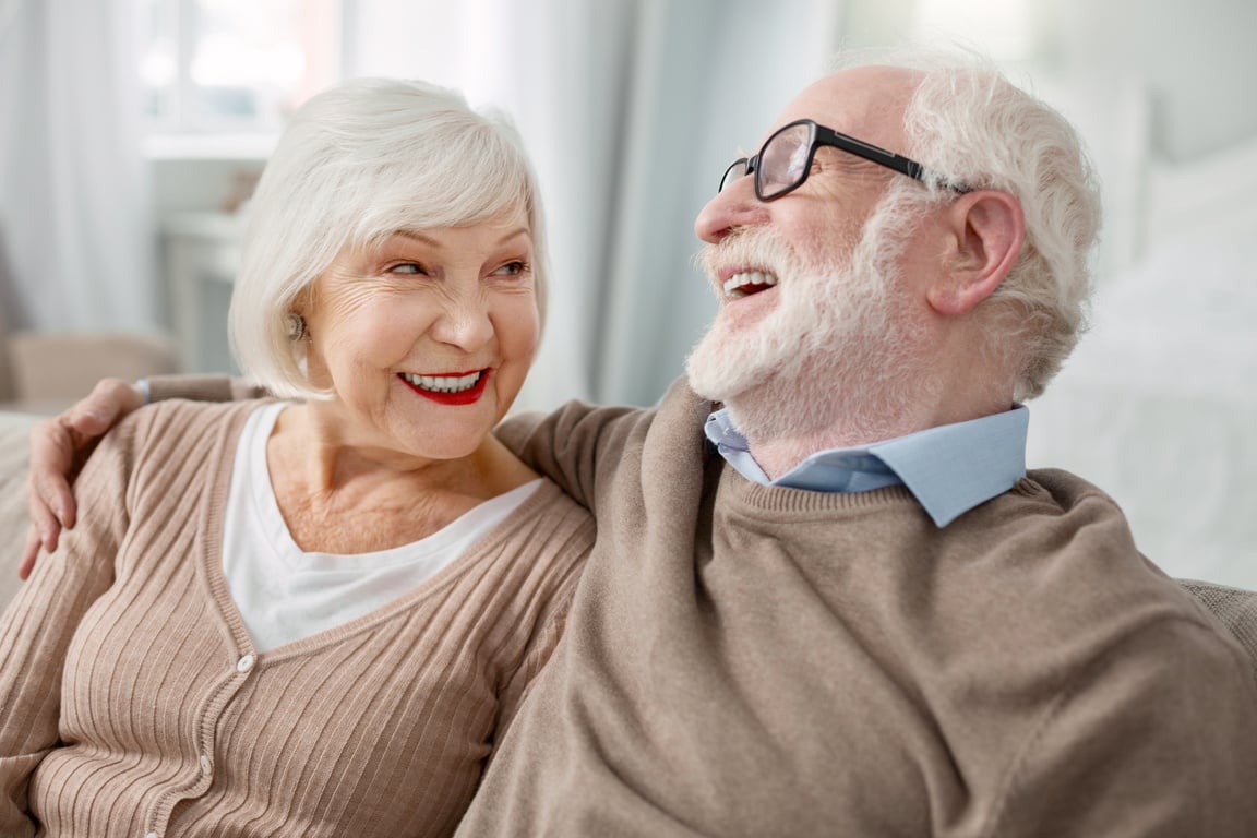 Cheerful elderly man hugging his wife